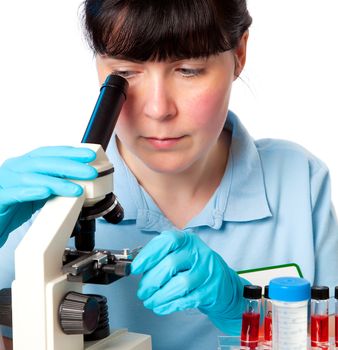 Girl working at the laboratory with microscope