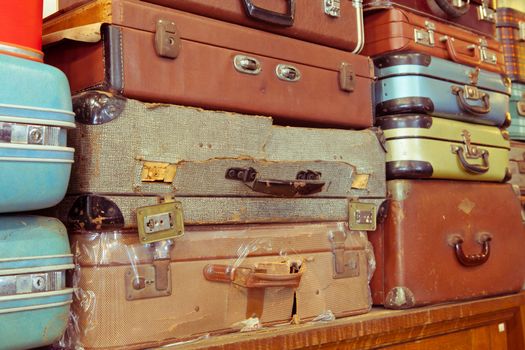 Vintage old battered leather suitcases stacked