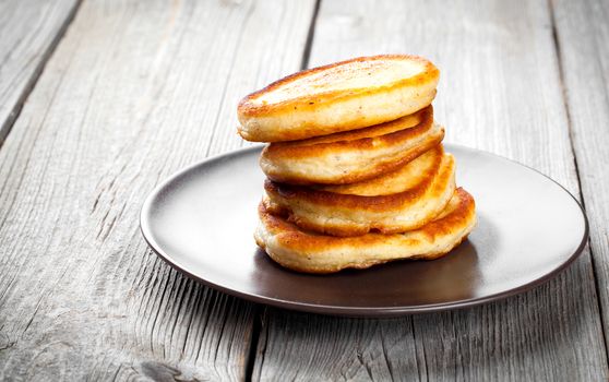Stack of pancakes on wooden background