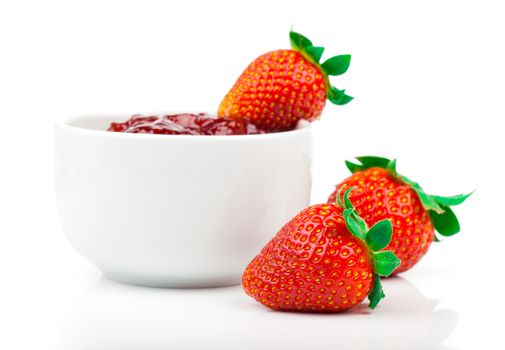 Strawberry jam and fresh berries isolated on white