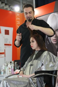 Model during hairdressing-styling  at 23th iinternational fair and congress of cosmetics, solarium, equipment, wellness, spa and hair care, the largest beauty fair in South-east Europe, The touch of Paris, 26th and 27th April 2014. Belgrade,Serbia