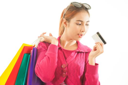 Portrait of young asian woman holding credit card and shopping bags isolated on white background