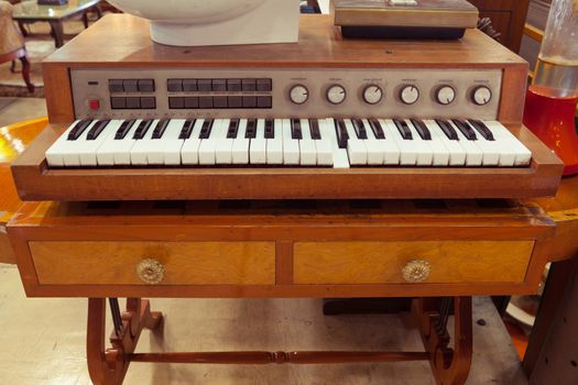 Closeup of antique piano keys and wood grain