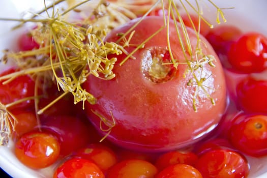 Photo of red tomato in brine with dill