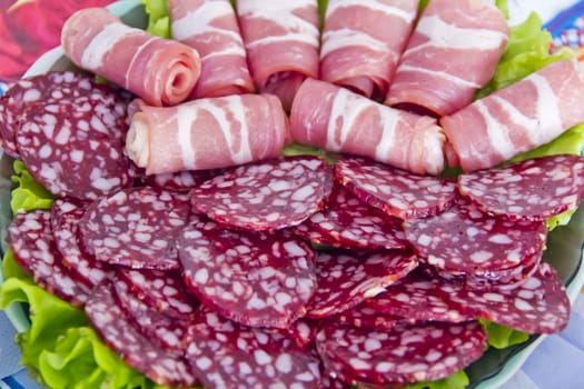 Photo with appetizing sausage and meat on the table