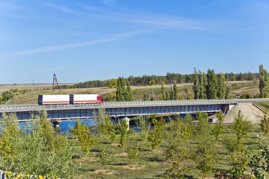 Photo of landscape with bridge and lorry