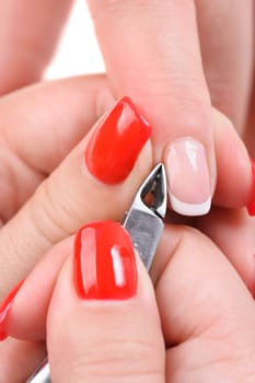 beauty salon, manicure applying, cutting the cuticle with scissors