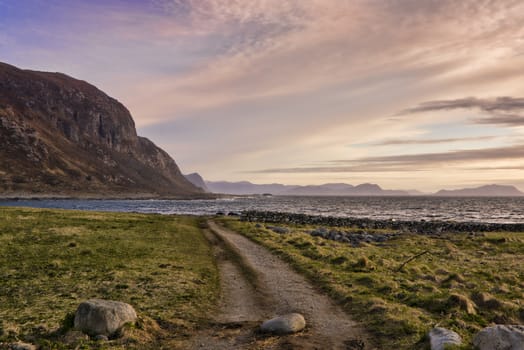 The western coast of Norway in the evening with pink clouds