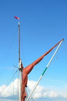 Rolled up thames barge sail