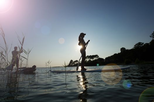 Family in holiday on a paddleboard in sunchin