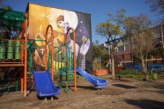 Colourful murals adorning the walls of tenement blocks in the San Miguel area of Santiago, capital of Chile. The area was created as an open air museum in what was a run down area of the city.