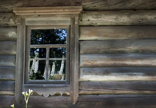 Old window on a wooden farm house wall