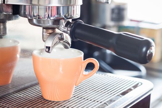 Orange coffe cup prepares for espresso, stock photo