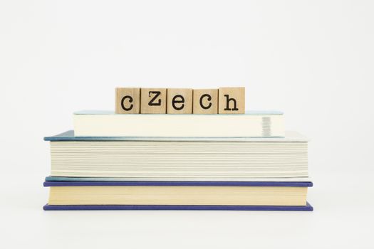 czech word on wood stamps stack on books, language and study concept