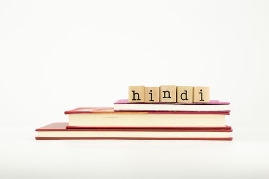 hindi word on wood stamps stack on books, language and study concept