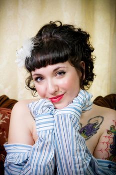 Portrait of rockabilly girl in a striped shirt, in a Victorian setting.
