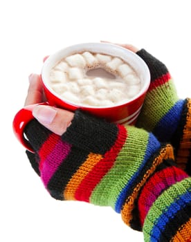 A mug of hot chocolate, complete with miniature marshmallows, warms cold hands on a cold day.  Shot on white background.
