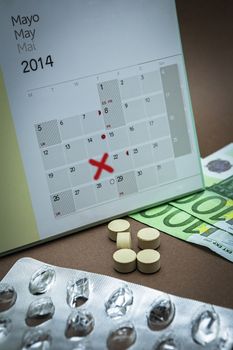 control pills on a calendar, reminder to pay for medicines in the Pharmacy