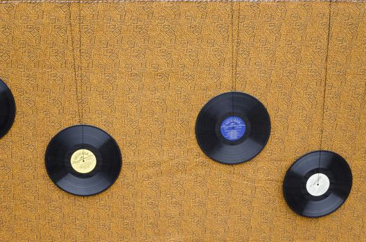 wall covered with thick tapestry material decorated with musical plates