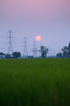 Electric power station in the field on sunset