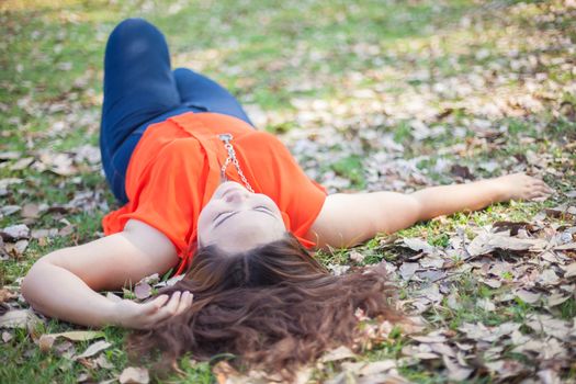 Happy fatty asian woman posing outdoor in a park