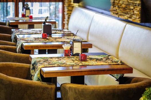 Modern restaurant interior with tables and sofas