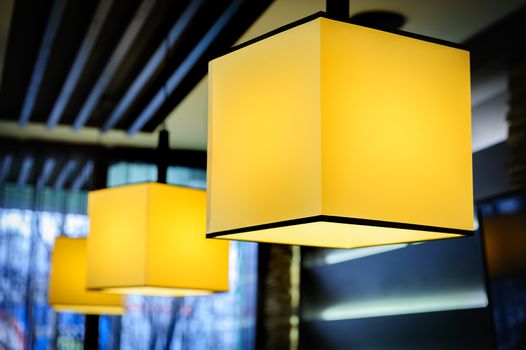 Modern restaurant interior with yellow square lamps