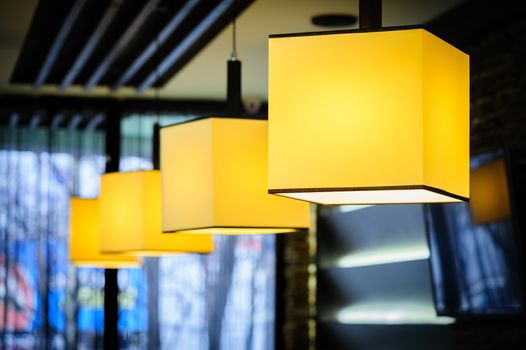 Modern restaurant interior with yellow square lamps