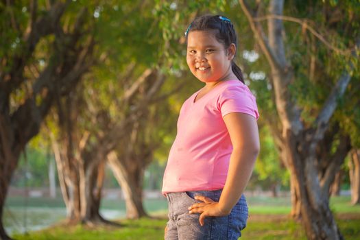 Portrait asian fat girl in the park on sunset