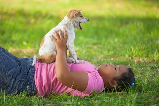 little asian girls and puppy in the garden