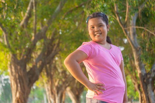 Portrait asian fat girl in the park on sunset