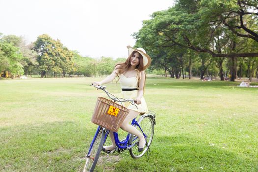 Women who are cycling in the park during a sunny weekend.