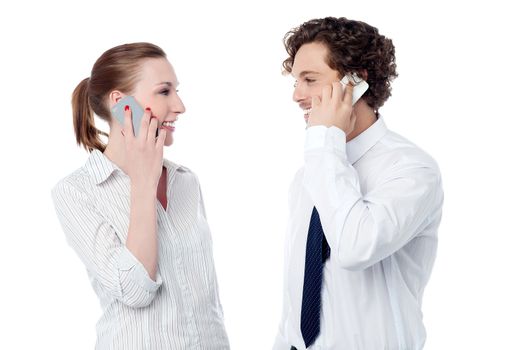 Young colleagues communicating over cell phone