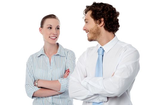 Smiling businesswoman and businessman looking each other