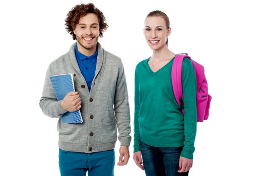 Smiling young students with bag and note book