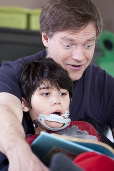 Father reading book with disabled son