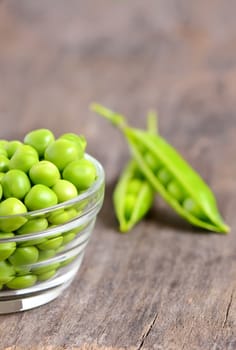 Fresh peas isolated on old wooden background