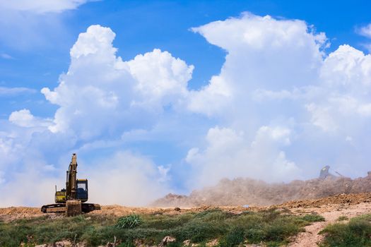 Excavator loading dumper truck tipper in construction site