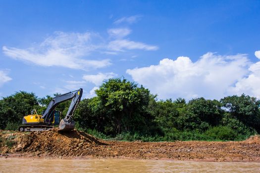 Excavator loading dumper truck tipper in construction site