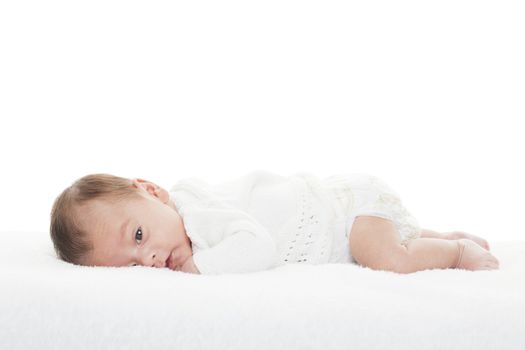 A mixed race newborn baby boy staring at the camera.  Shot on white background.