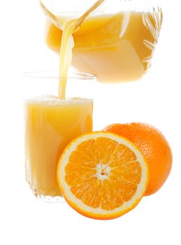 Sweet, refreshing orange juice being poured into a glass.  Studio isolated on white background.