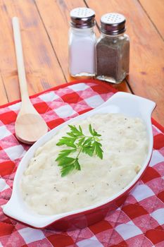 Creamy scalloped potatoes garnished with Italian parsley.