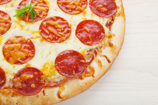 Closeup of pepperoni pizza on a wooden board.