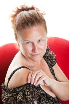 Portrait of a confident, fifty year-old woman with hair pulled back and no makeup on.  Shot on white background.