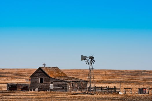 An abandoned homestead in a dry prairie landscape.  Hdr used for effect.
