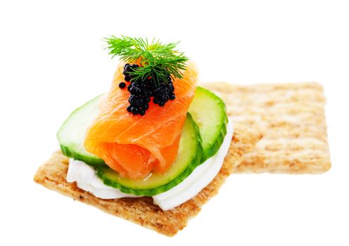 Beluga Caviar on fresh, raw salmon with baby cucumber and goat cheese; garnished with a sprig of fresh dill. 