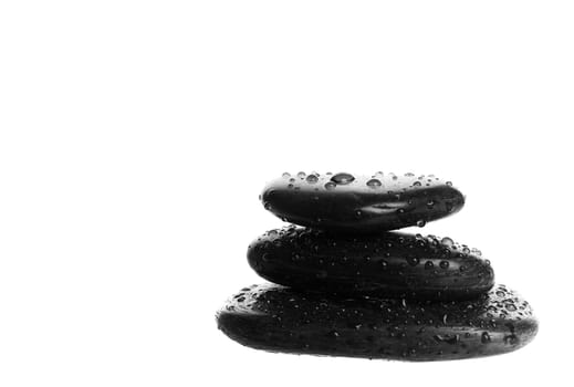 Zen massage stones with water droplets.  Shot on white background.