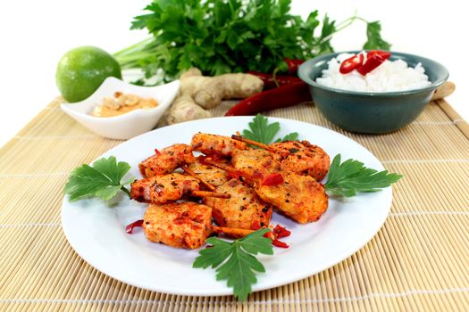 Skewer with hot peppers on a white plate