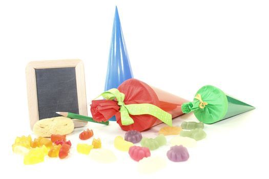 School bag with pen, sponge, blackboard and sweets on a light background