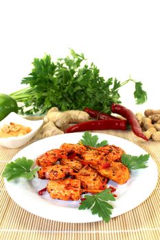 Skewer with hot peppers on a white plate